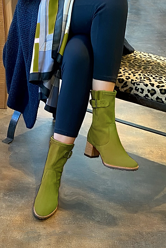Pistachio green women's ankle boots with buckles on the sides. Round toe. Medium block heels. Worn view - Florence KOOIJMAN